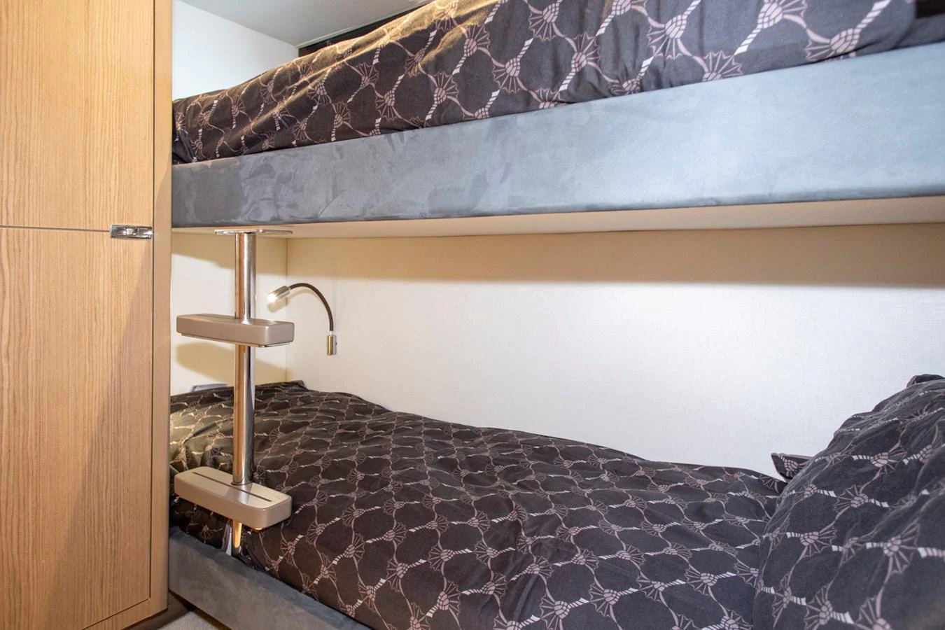 The image showcases a cozy cabin with bunk beds, perfect for accommodating guests. aboard BK ONE Yacht for Sale