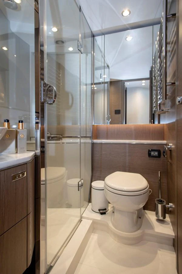 A sleek and modern yacht bathroom with glass shower enclosure and elegant fixtures. aboard BK ONE Yacht for Sale