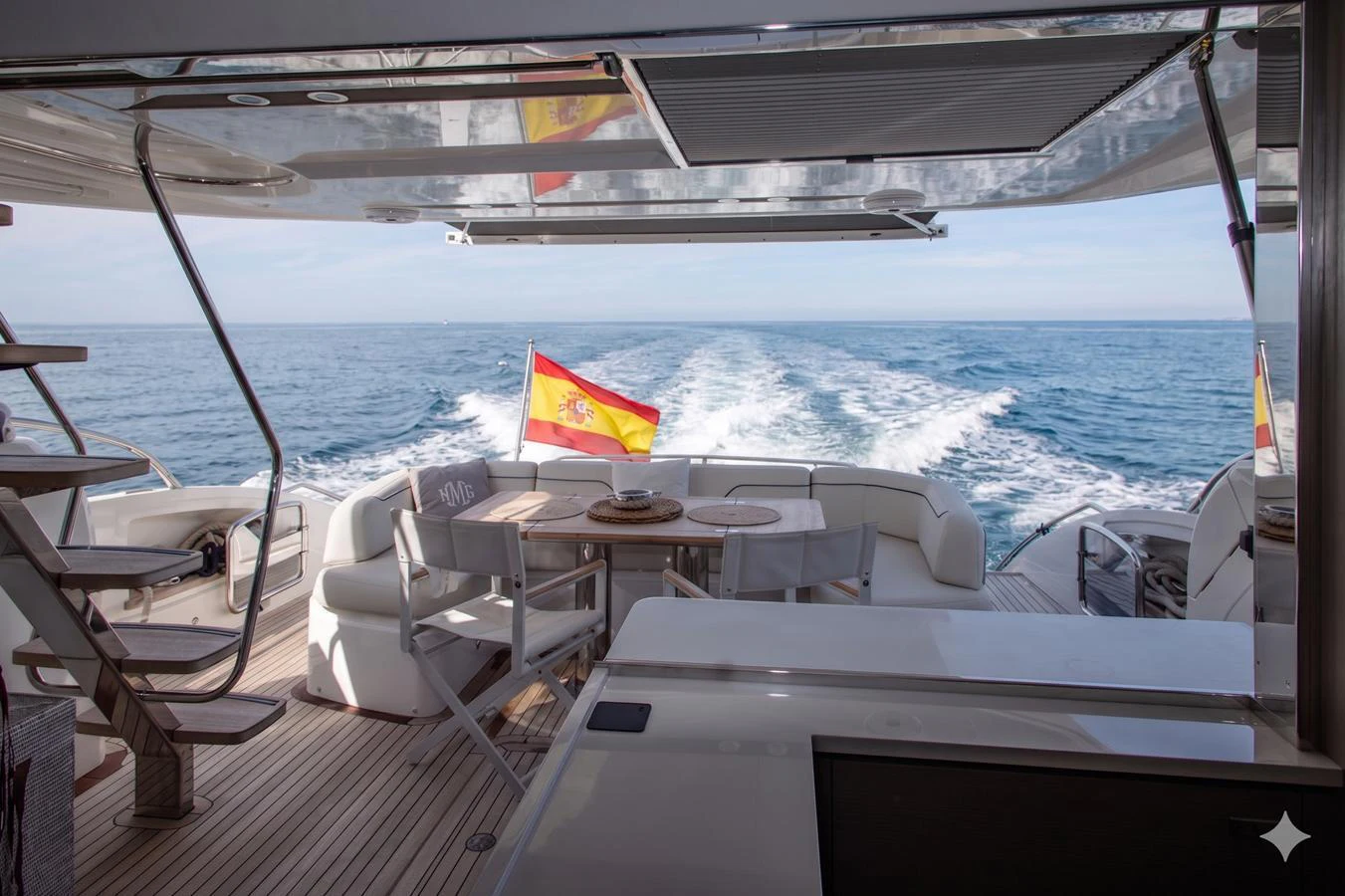 The aft deck offers a spacious seating area with a dining table, perfect for enjoying meals with a view of the open sea. aboard BK ONE Yacht for Sale