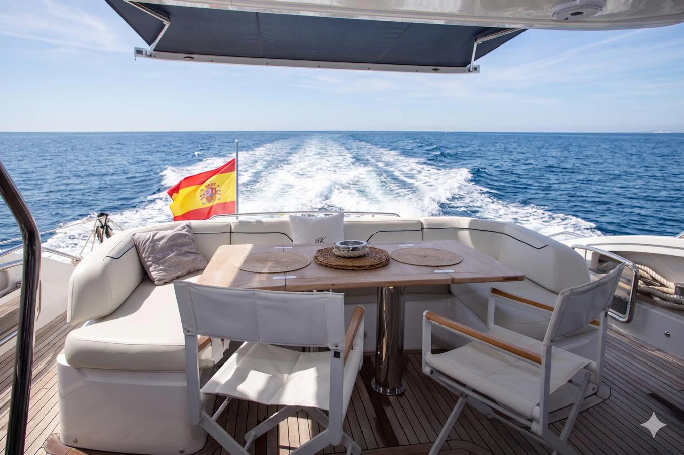 The aft deck offers a serene dining area with stunning ocean views. aboard BK ONE Yacht for Sale