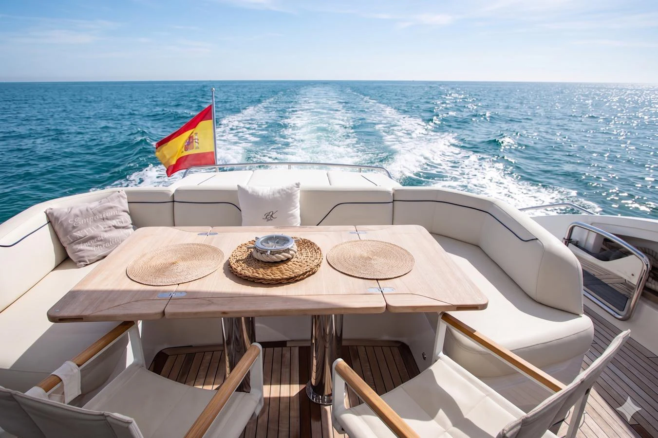The aft deck features a comfortable dining area with a stunning view of the open sea. aboard BK ONE Yacht for Sale