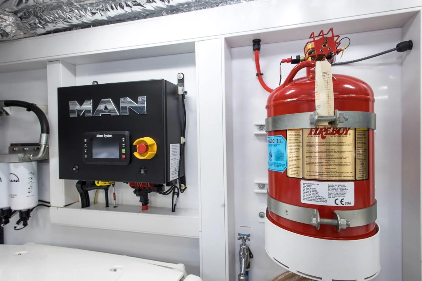 The image showcases a well-organized engine room with essential safety and control equipment. aboard BK ONE Yacht for Sale