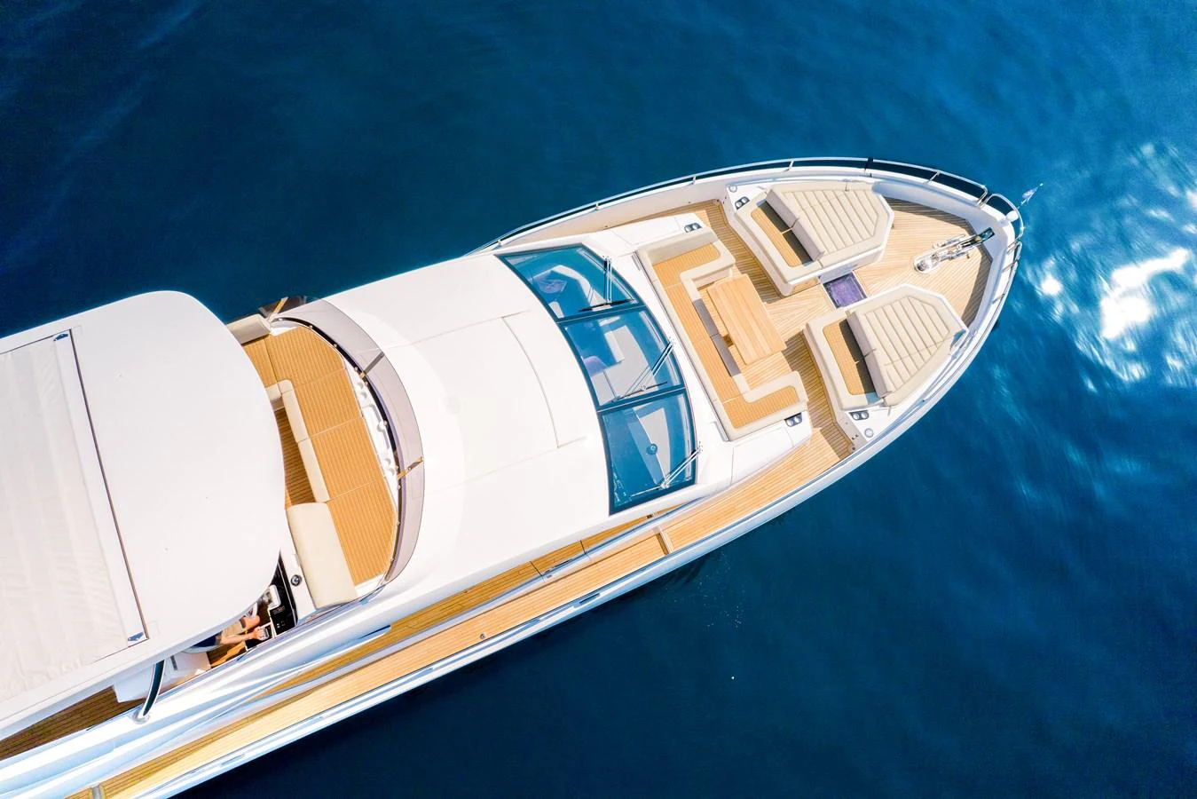 The yacht's foredeck features a spacious sunbathing area with luxurious seating and a sleek design. aboard SUNSEEKER 76Y Yacht for Sale