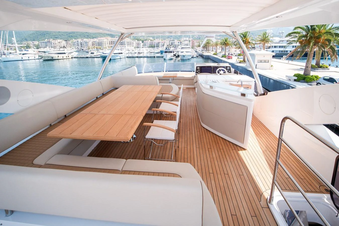 The flybridge offers a spacious and elegant outdoor dining and lounging area with stunning marina views. aboard SUNSEEKER 76Y Yacht for Sale
