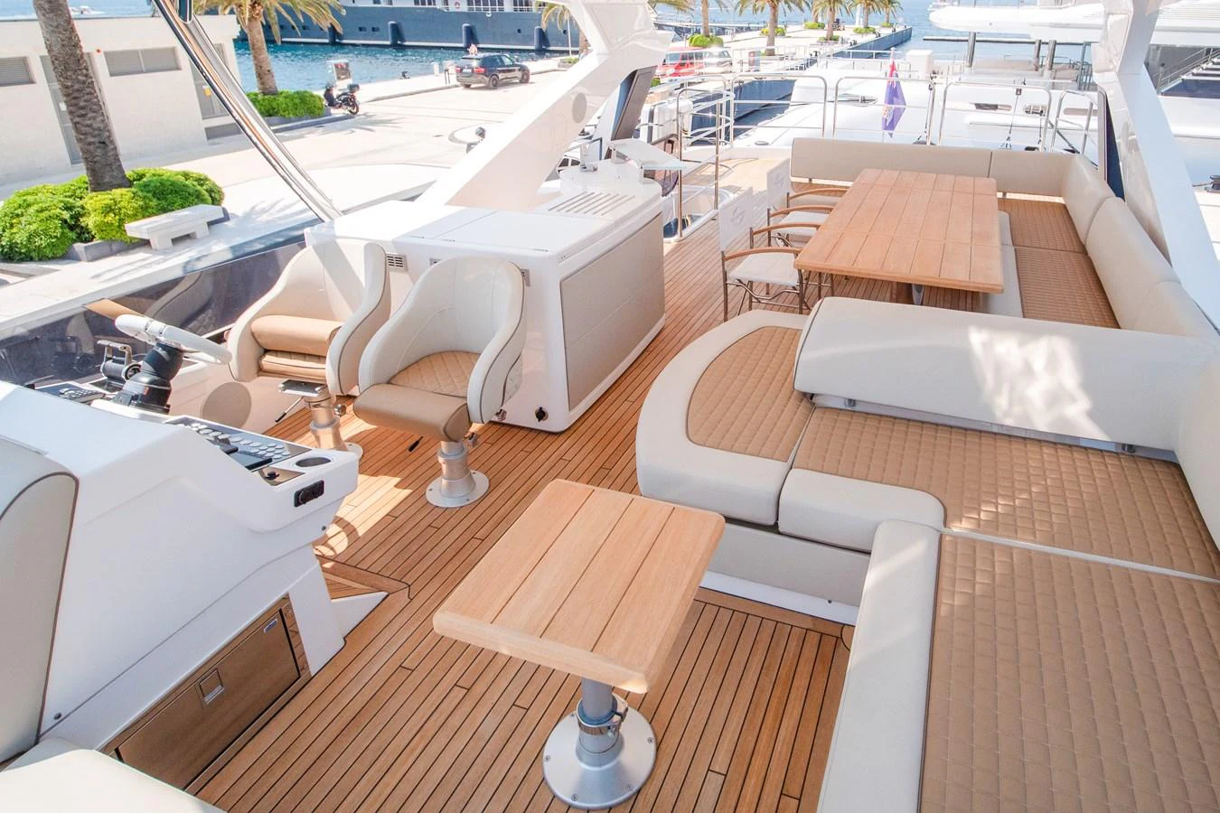 The flybridge features spacious seating and dining areas with elegant wooden accents. aboard SUNSEEKER 76Y Yacht for Sale