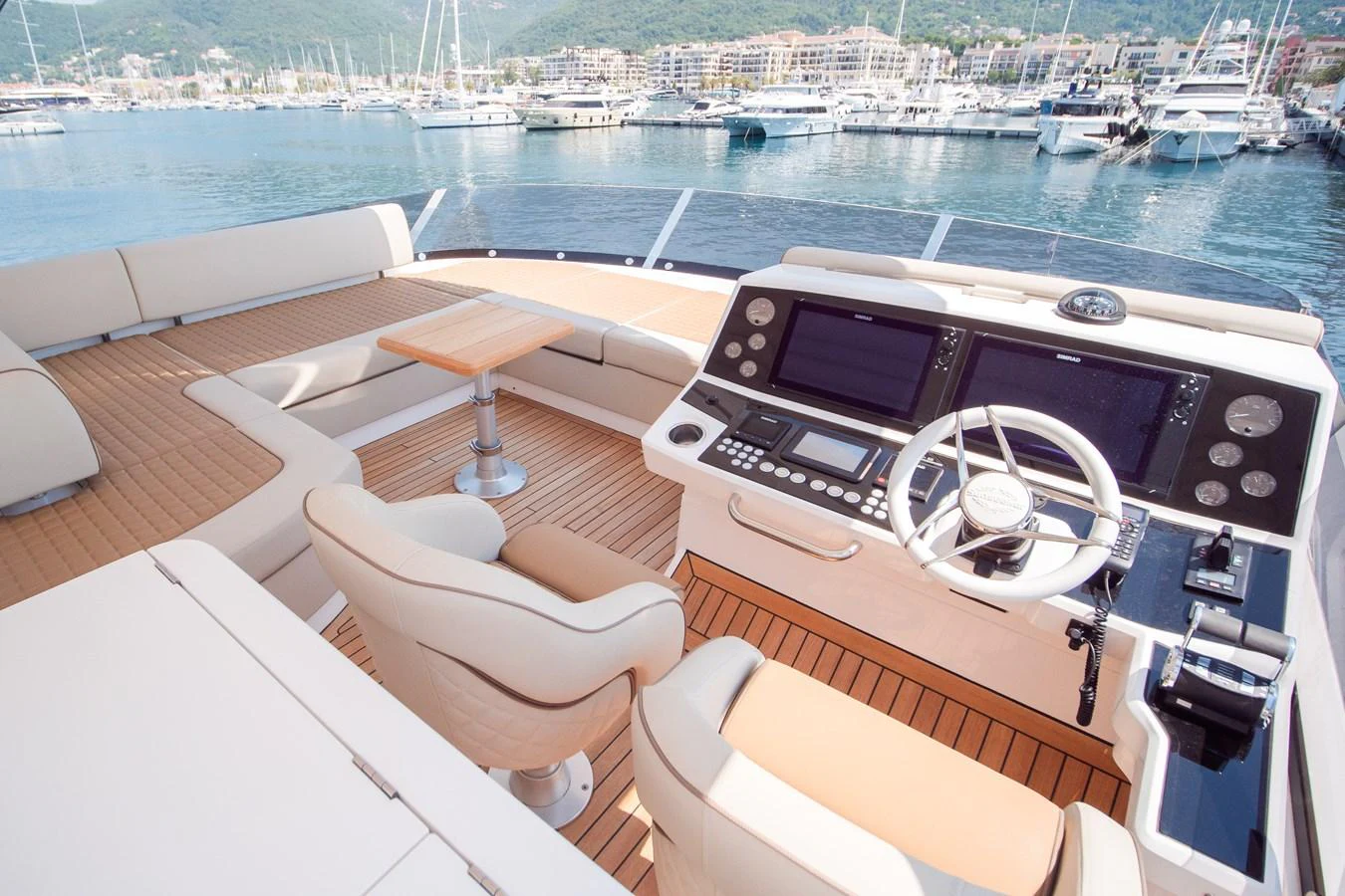 The helm station offers a luxurious and well-equipped command center with comfortable seating and advanced navigation systems. aboard SUNSEEKER 76Y Yacht for Sale