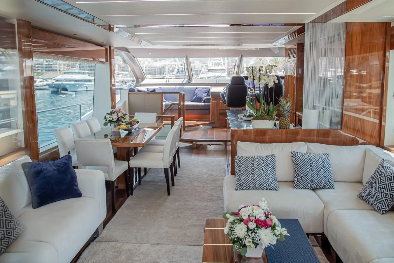 The salon features elegant seating, a dining area, and large windows offering stunning views. aboard SUNSEEKER 76Y Yacht for Sale