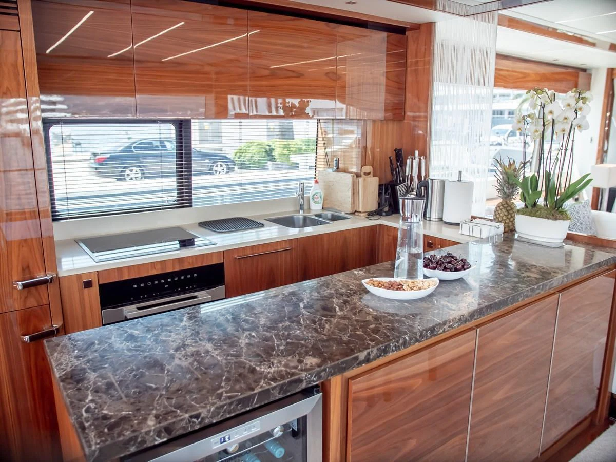 The yacht's galley features a sleek, modern design with high-end appliances and luxurious finishes. aboard SUNSEEKER 76Y Yacht for Sale