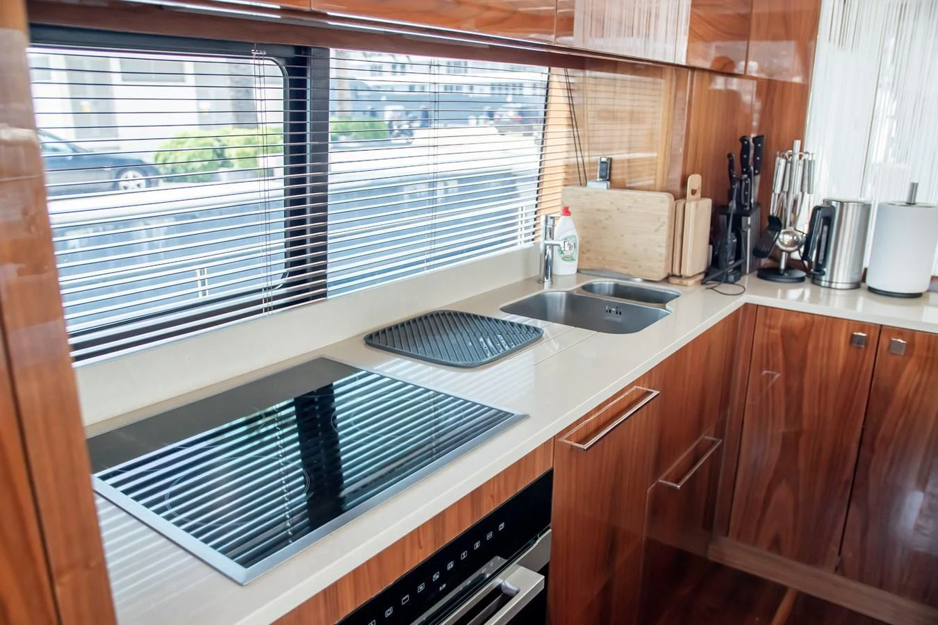 The galley features modern appliances and sleek wooden cabinetry, offering a stylish and functional space for meal preparation. aboard SUNSEEKER 76Y Yacht for Sale