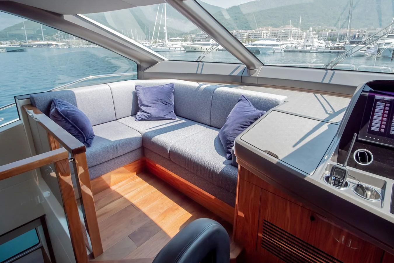 The salon features a cozy seating area with plush cushions and panoramic windows offering stunning views. aboard SUNSEEKER 76Y Yacht for Sale