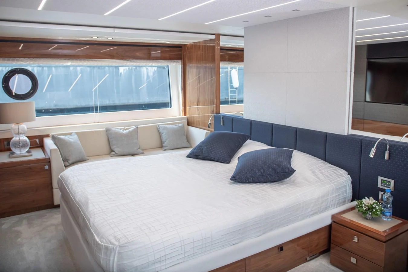 The master stateroom features a spacious bed with elegant bedding and ample natural light from large windows. aboard SUNSEEKER 76Y Yacht for Sale