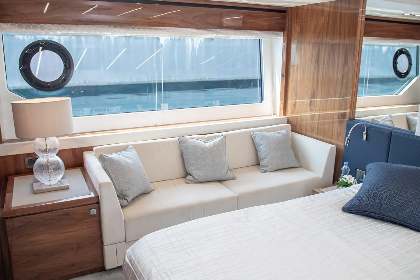 The stateroom features a comfortable seating area with a large window offering a view of the sea. aboard SUNSEEKER 76Y Yacht for Sale