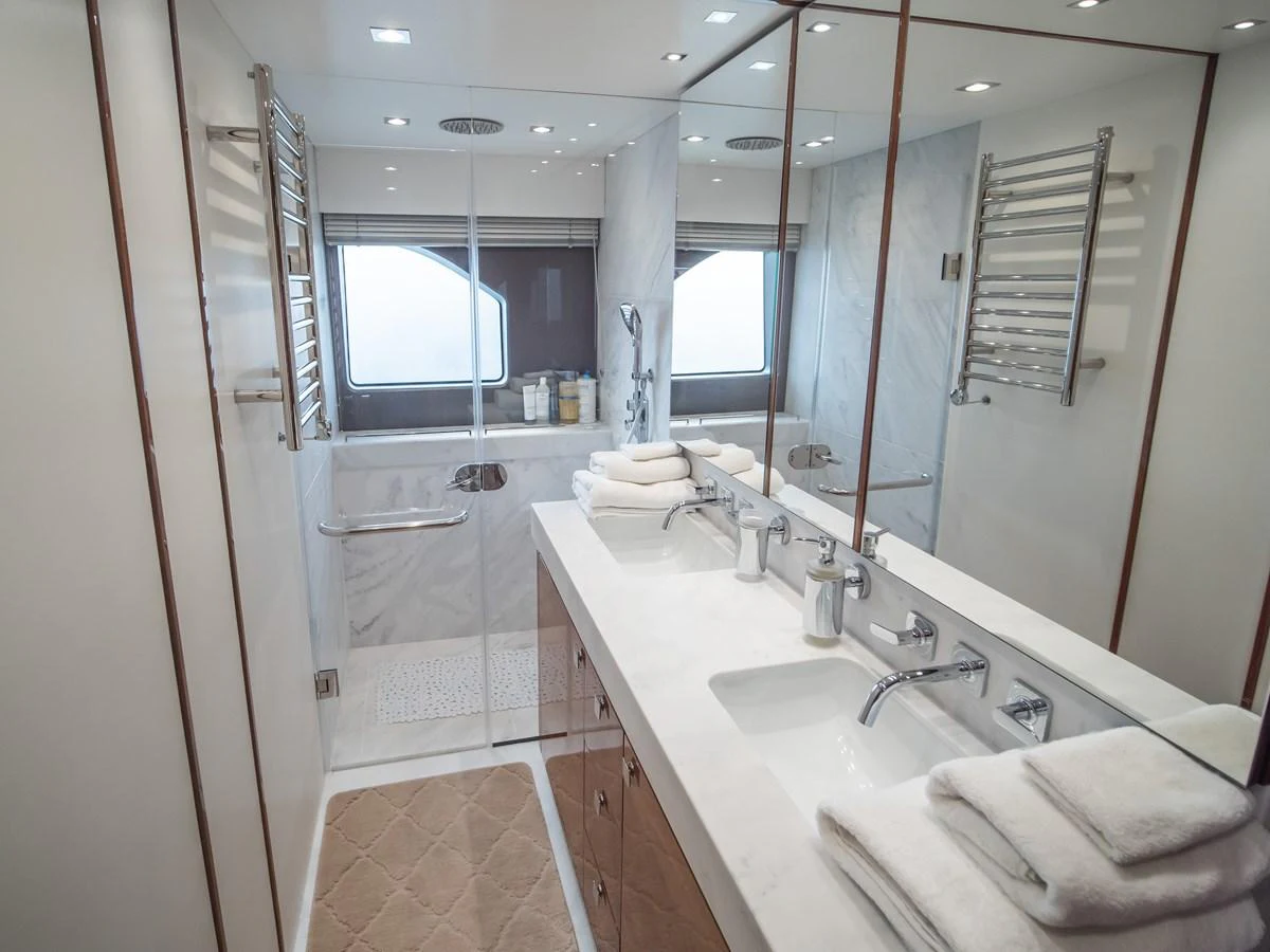 The yacht's bathroom features a sleek design with modern fixtures and ample natural light. aboard SUNSEEKER 76Y Yacht for Sale