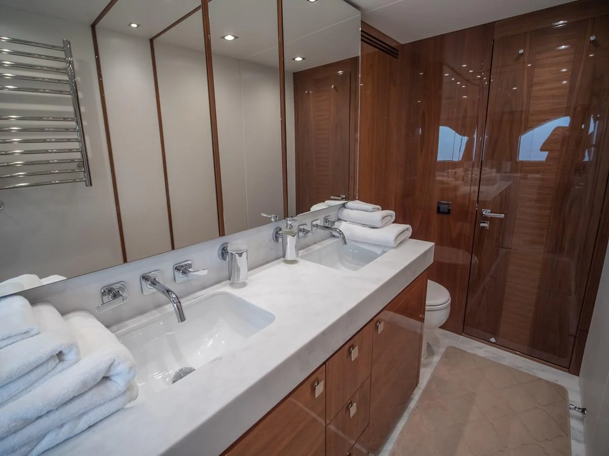 The yacht's bathroom features a sleek design with dual sinks and ample storage. aboard SUNSEEKER 76Y Yacht for Sale