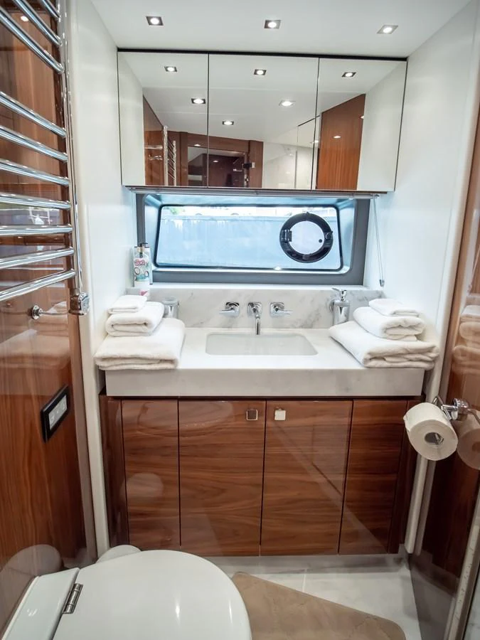 A luxurious yacht bathroom featuring a sleek vanity, ample storage, and modern fixtures. aboard SUNSEEKER 76Y Yacht for Sale