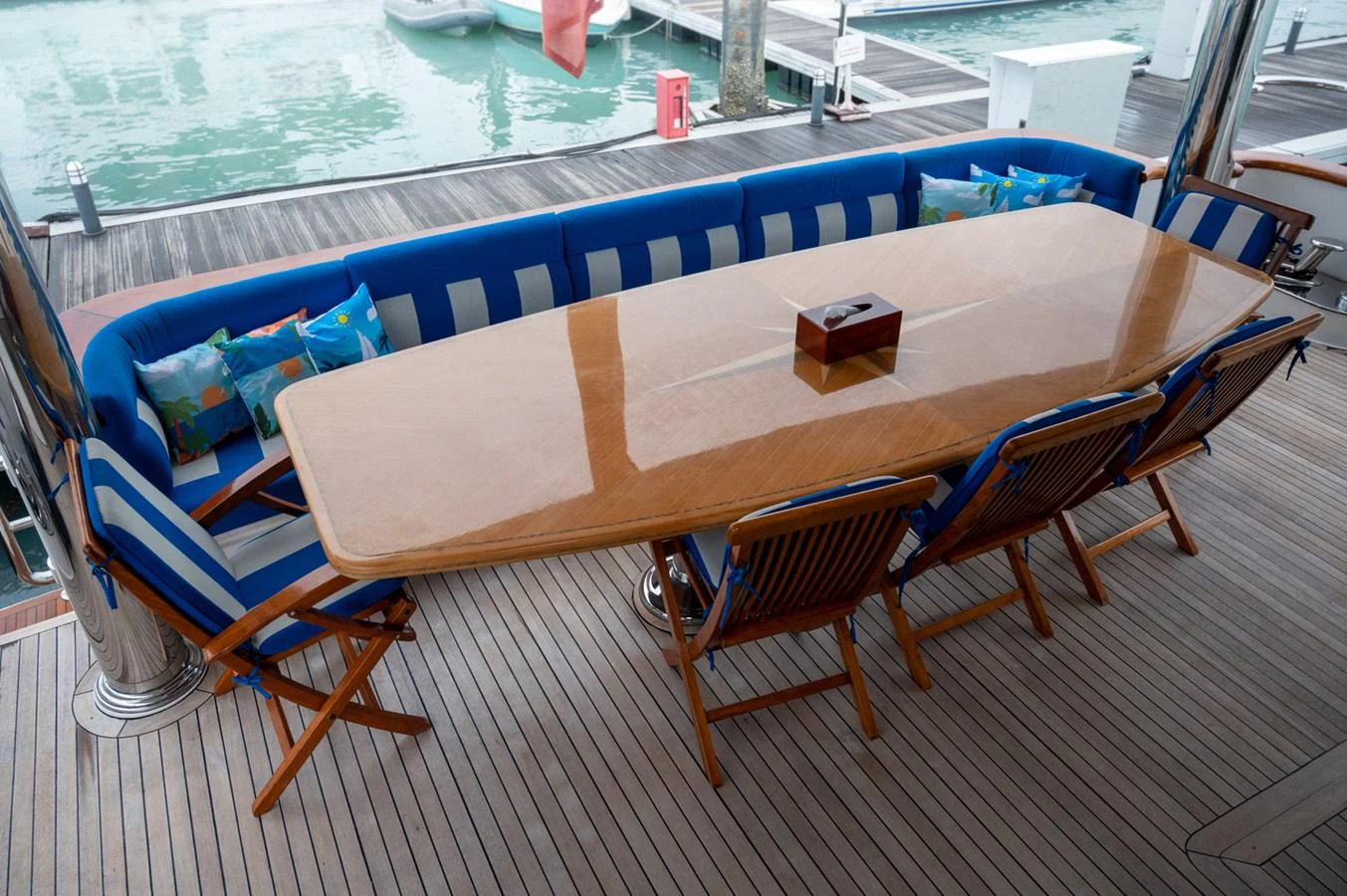The aft deck features a stylish dining area with a polished wooden table and comfortable seating. aboard LADY EILEEN Yacht for Sale