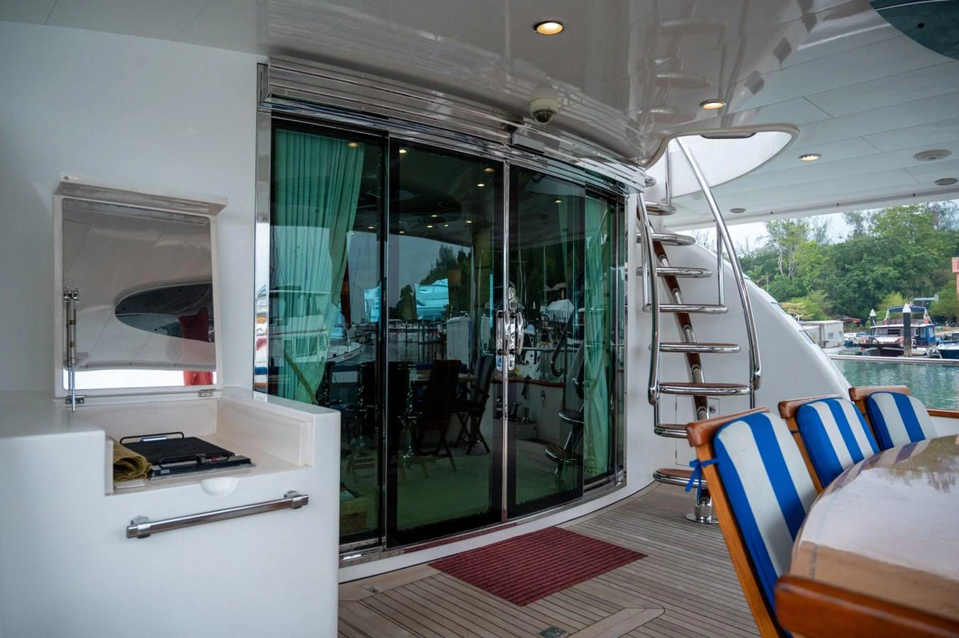 The aft deck features a comfortable seating area with a view of the marina. aboard LADY EILEEN Yacht for Sale
