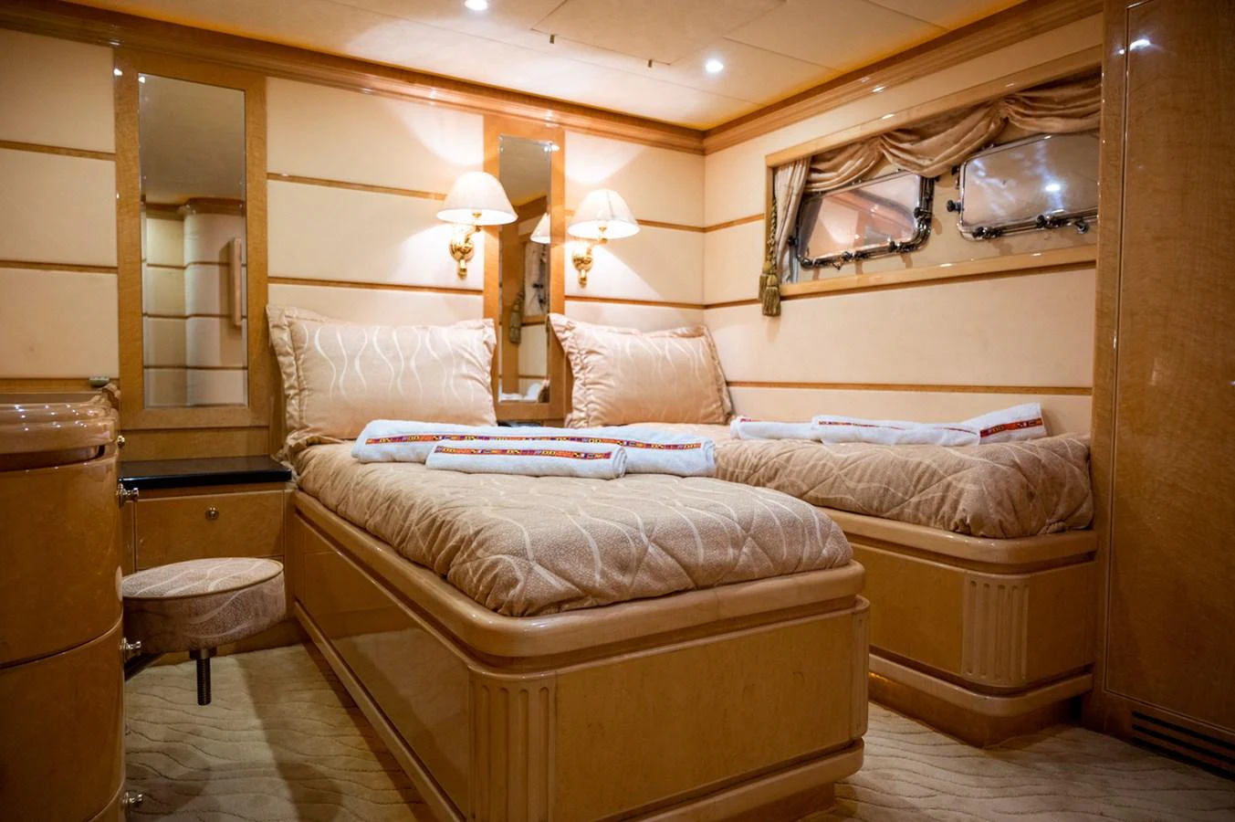 The guest stateroom features twin beds with luxurious bedding and warm lighting. aboard LADY EILEEN Yacht for Sale