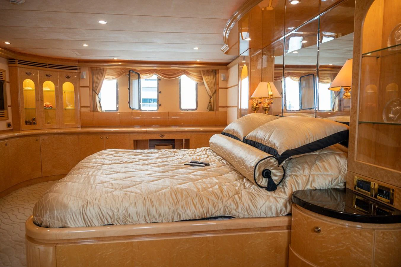The master stateroom features a luxurious bed with elegant bedding and ample natural light from the windows. aboard LADY EILEEN Yacht for Sale