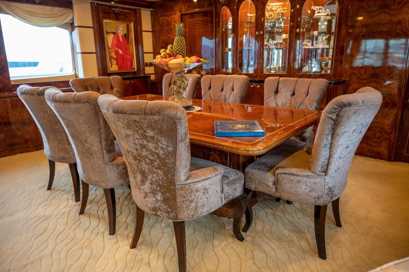 The yacht's dining area features a luxurious table surrounded by plush, upholstered chairs, perfect for elegant meals. aboard LADY EILEEN Yacht for Sale