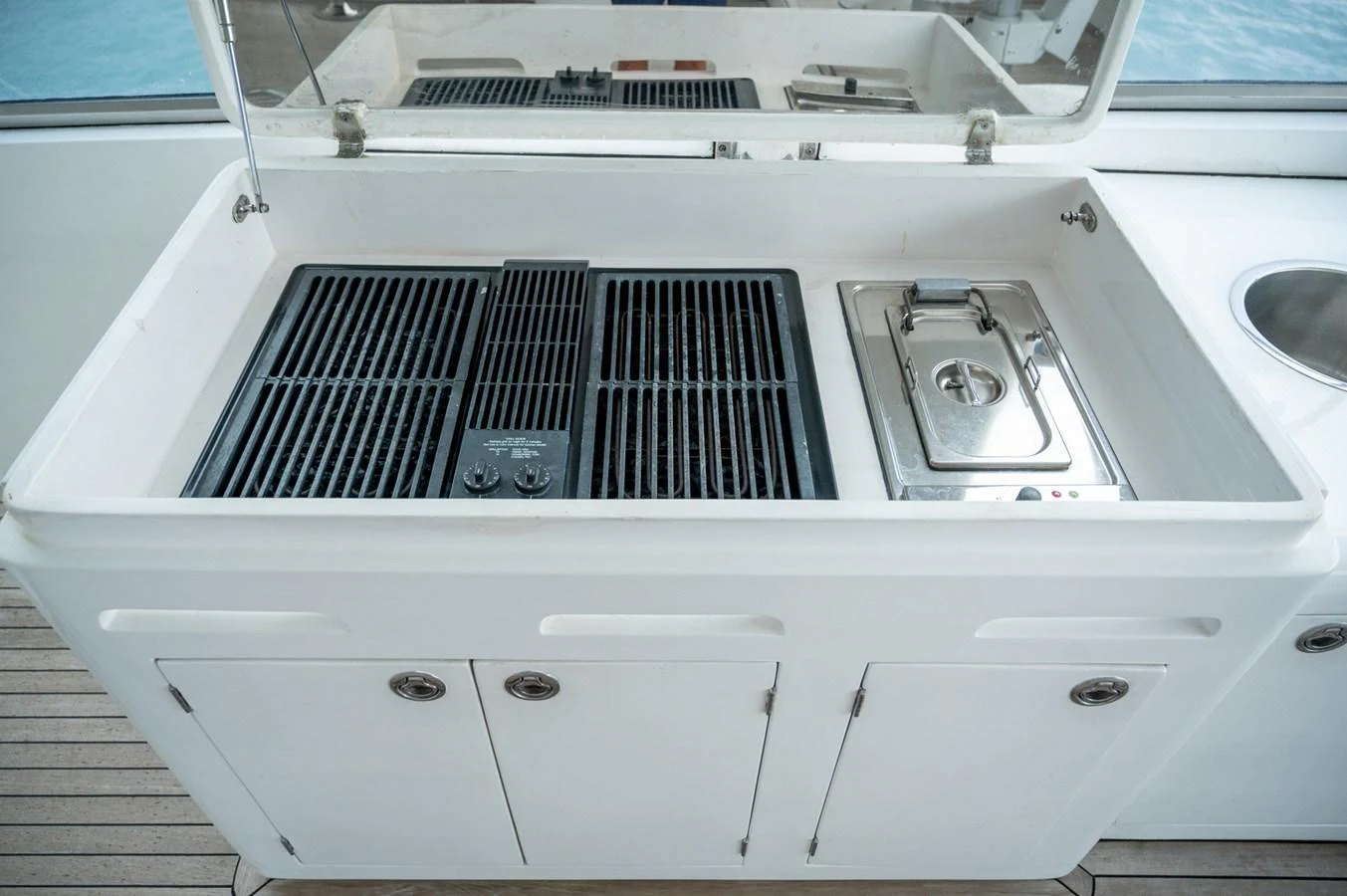 The yacht features a well-equipped outdoor galley with a grill and sink, perfect for alfresco dining. aboard LADY EILEEN Yacht for Sale