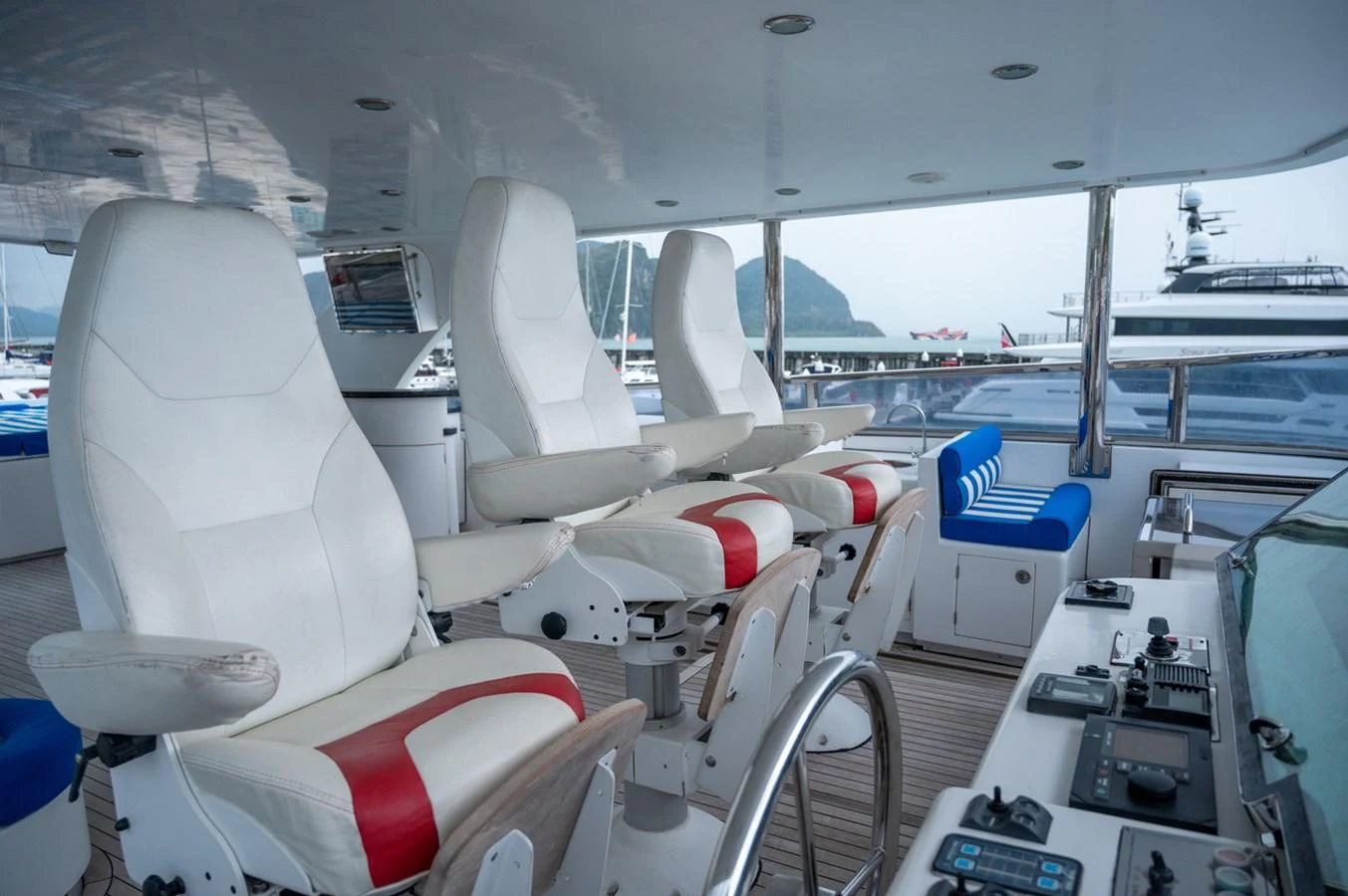 The helm station features modern controls and comfortable seating with a scenic view. aboard LADY EILEEN Yacht for Sale