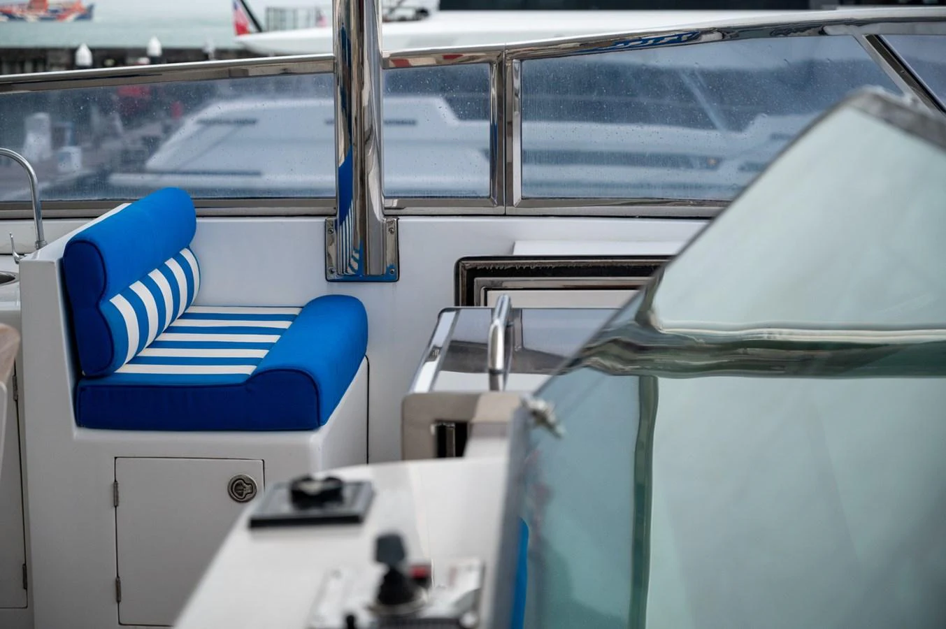 A close-up view of a yacht's seating area with blue and white striped cushions. aboard LADY EILEEN Yacht for Sale
