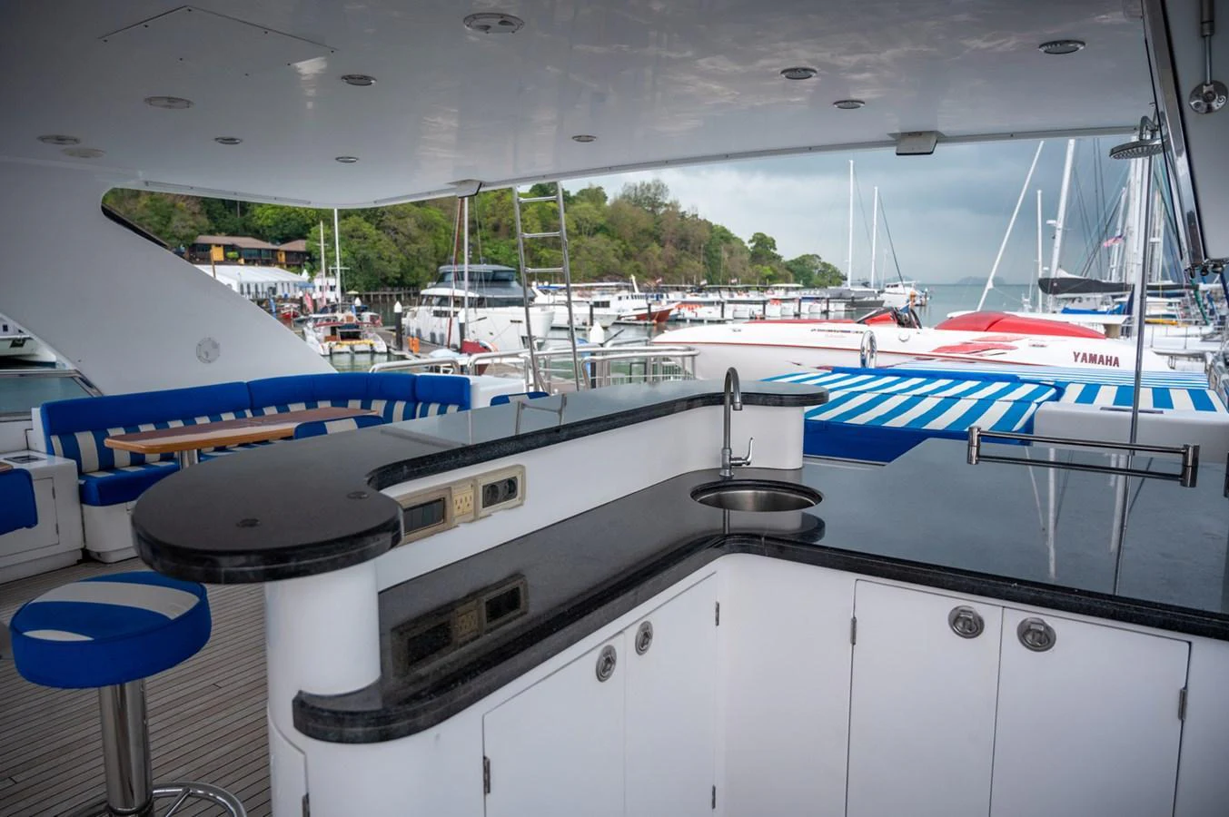 The aft deck features a stylish bar area with comfortable seating and a view of the marina. aboard LADY EILEEN Yacht for Sale