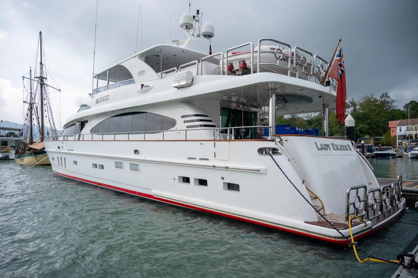 A sleek and elegant yacht docked at the marina, showcasing its modern design and spacious decks. aboard LADY EILEEN Yacht for Sale