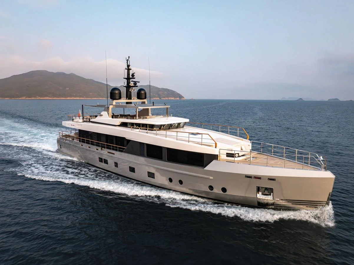 A sleek and modern yacht cruising on open waters with a scenic backdrop. aboard SUN PRINCE Yacht for Sale