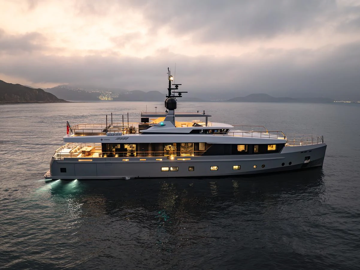 A sleek and modern yacht cruises gracefully on calm waters at dusk. aboard SUN PRINCE Yacht for Sale