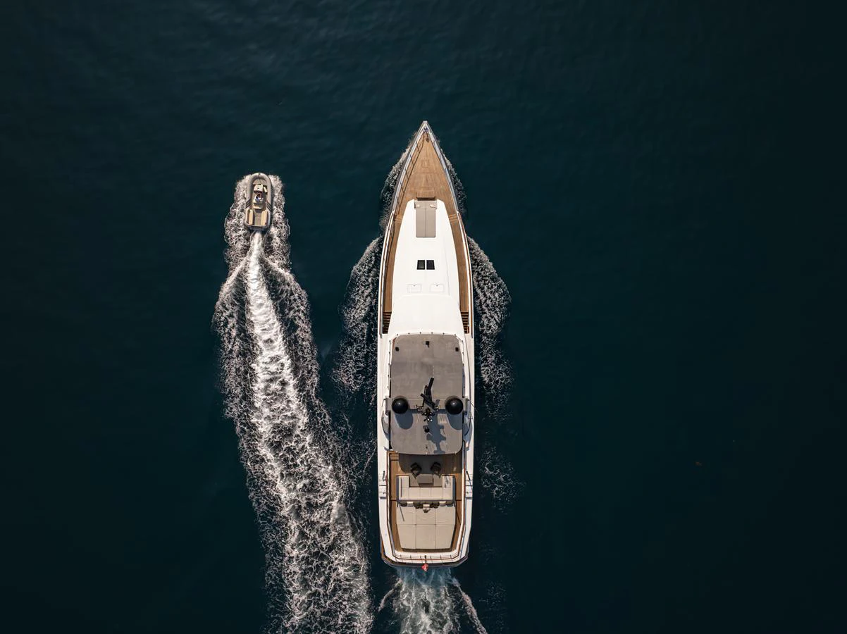An aerial view of a yacht cruising alongside a tender on open water. aboard SUN PRINCE Yacht for Sale