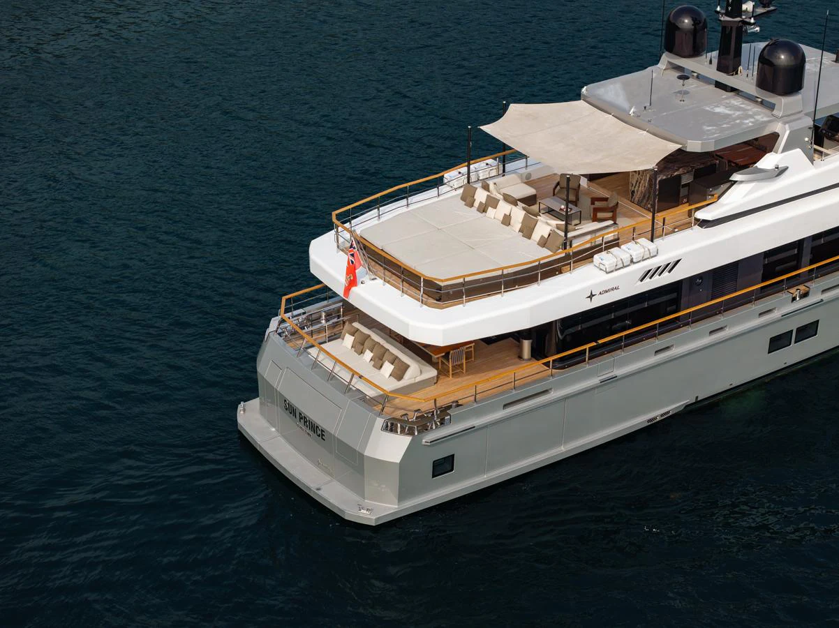The yacht's aft deck features a spacious lounging area with sunbeds and a shaded dining space, perfect for relaxation and entertainment. aboard SUN PRINCE Yacht for Sale