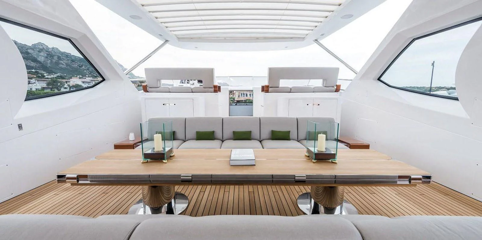 The yacht's salon features a spacious and elegant seating area with a large wooden table and modern decor. aboard PANTERA Yacht for Sale