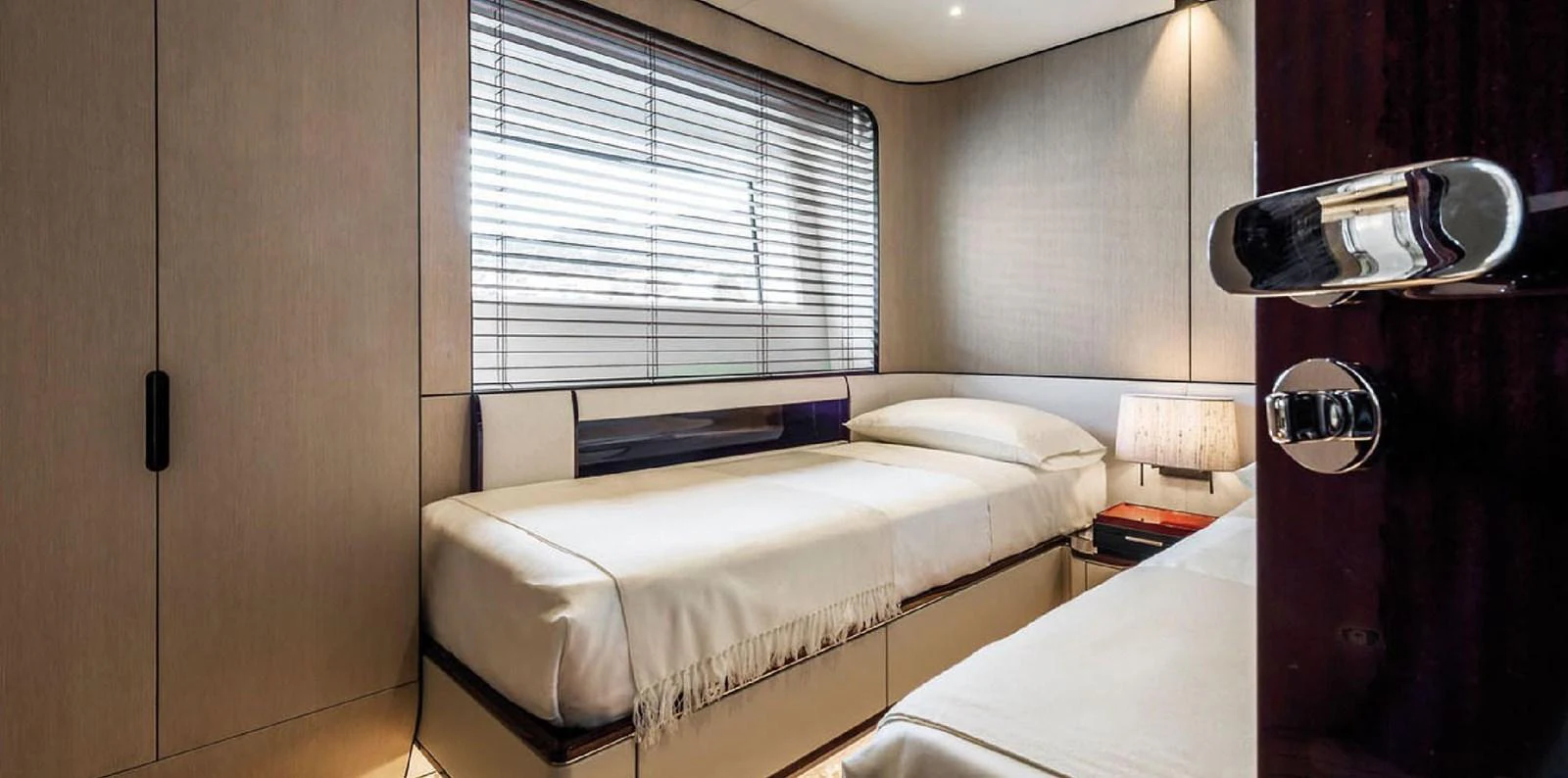 The guest stateroom features twin beds with a modern, minimalist design. aboard PANTERA Yacht for Sale