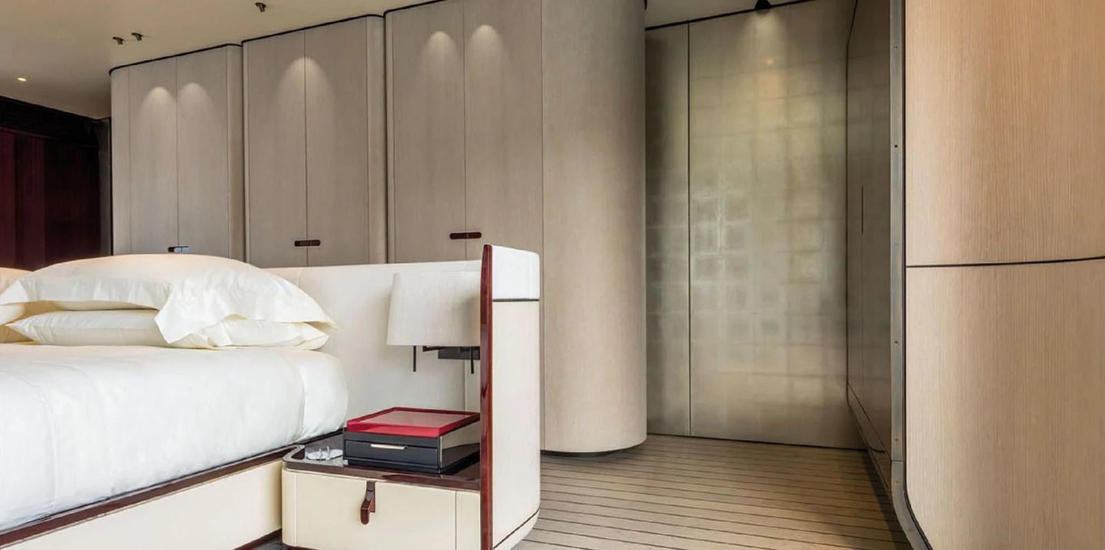 The stateroom features a luxurious bed with elegant cabinetry and modern lighting. aboard PANTERA Yacht for Sale