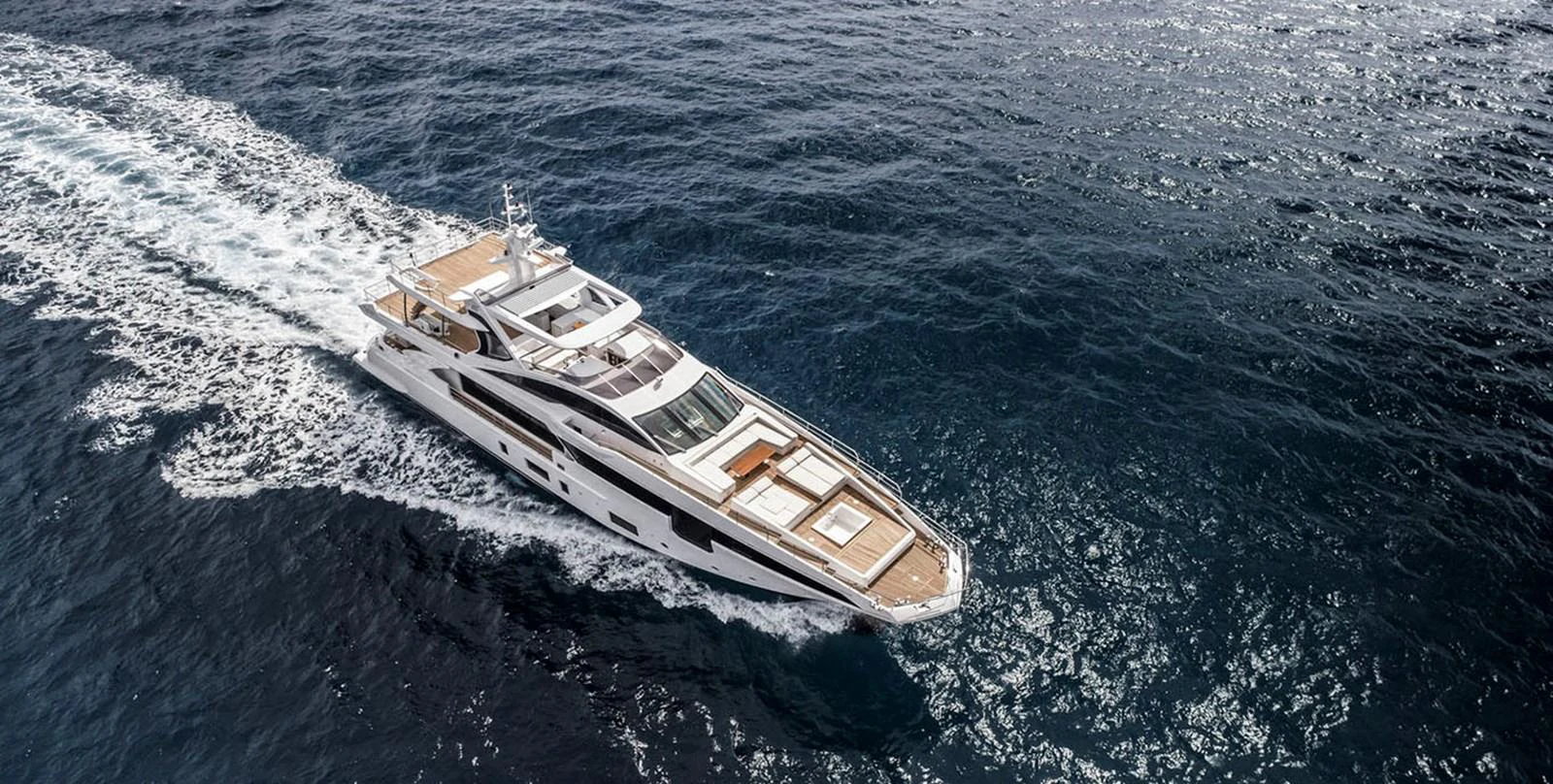 A sleek and modern yacht cruises gracefully through the open sea. aboard PANTERA Yacht for Sale