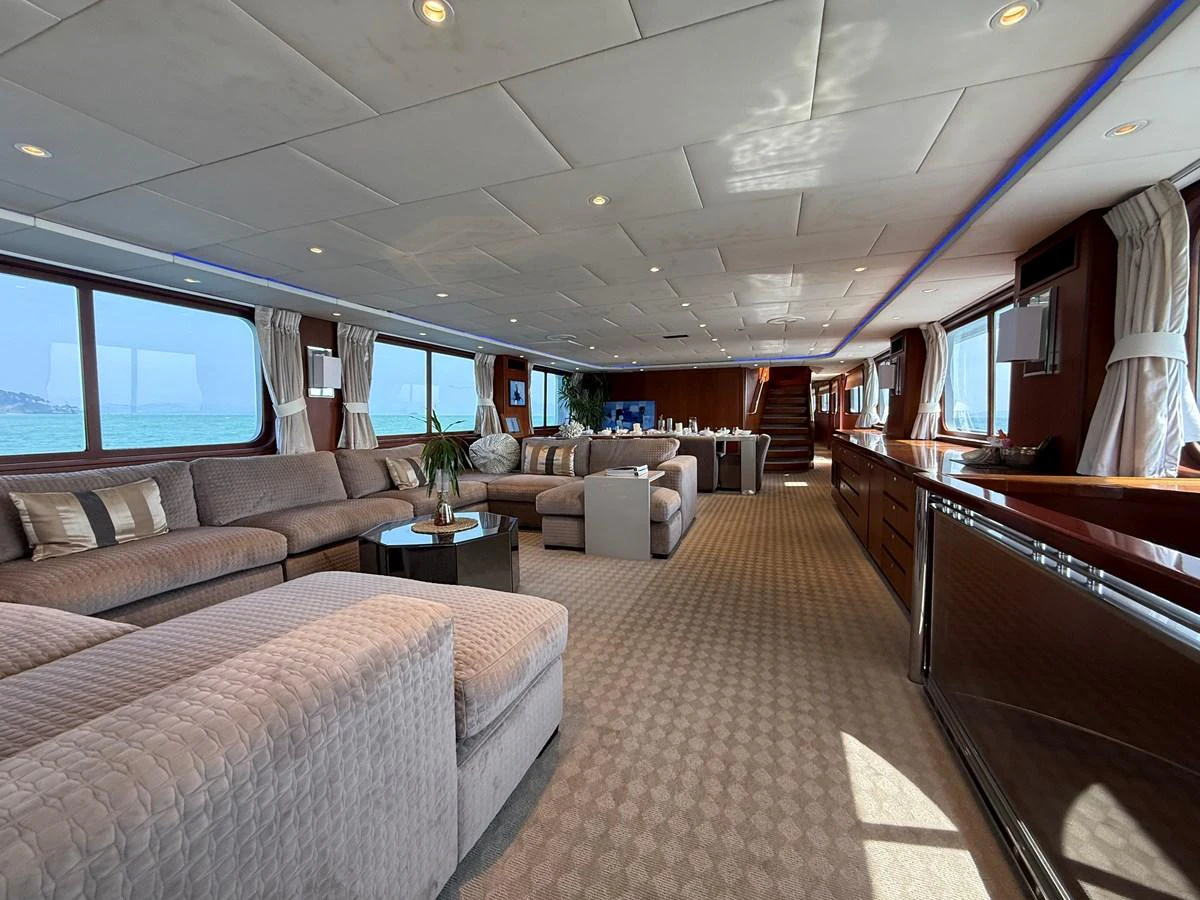 The spacious salon features plush seating, large windows, and elegant decor, offering a luxurious and comfortable space for relaxation. aboard LIGAYA Yacht for Sale