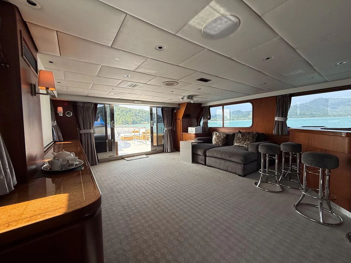 The yacht's salon offers a spacious and comfortable area with ample seating and natural light. aboard LIGAYA Yacht for Sale