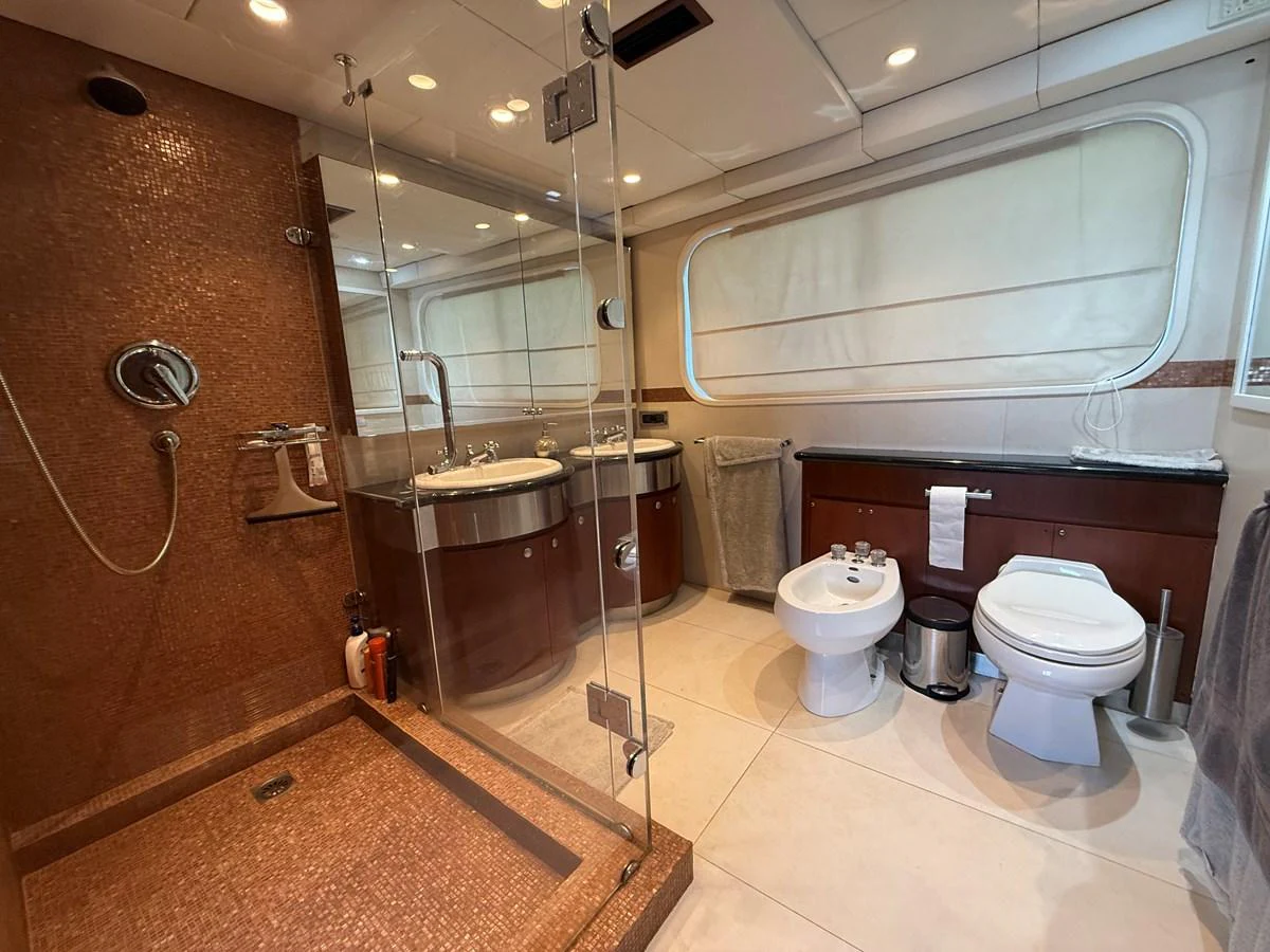 The yacht's bathroom features a spacious shower, modern fixtures, and elegant finishes. aboard LIGAYA Yacht for Sale
