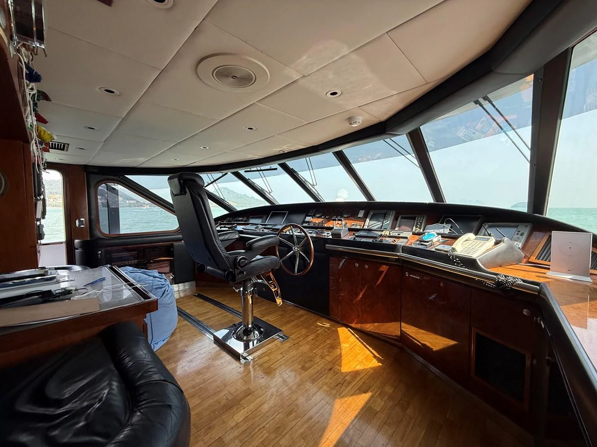 The helm station features a sleek design with panoramic windows and state-of-the-art navigation equipment. aboard LIGAYA Yacht for Sale