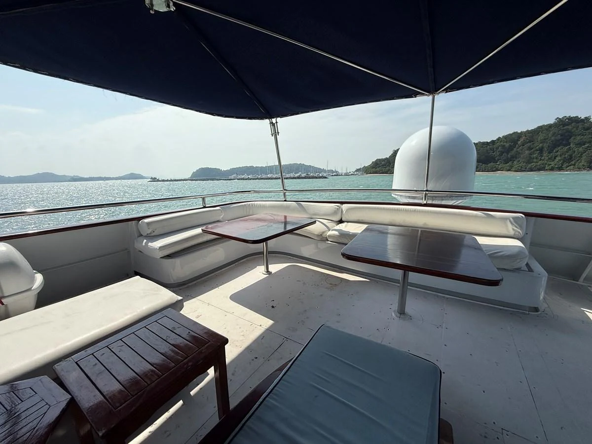 The aft deck offers a shaded seating area with stunning views of the surrounding waters. aboard LIGAYA Yacht for Sale