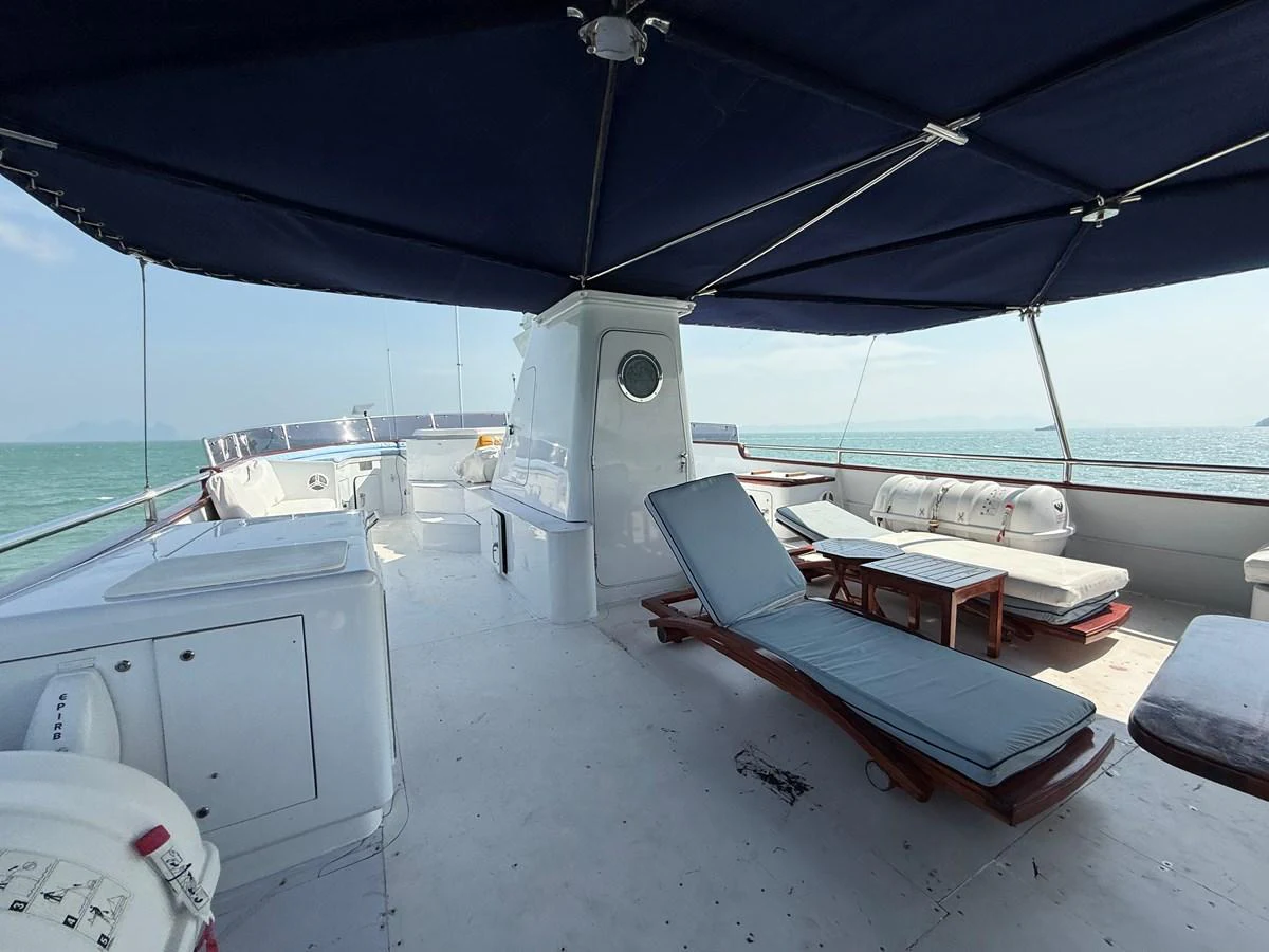 The sundeck offers a spacious and shaded area with comfortable lounge chairs and ample seating for relaxation. aboard LIGAYA Yacht for Sale
