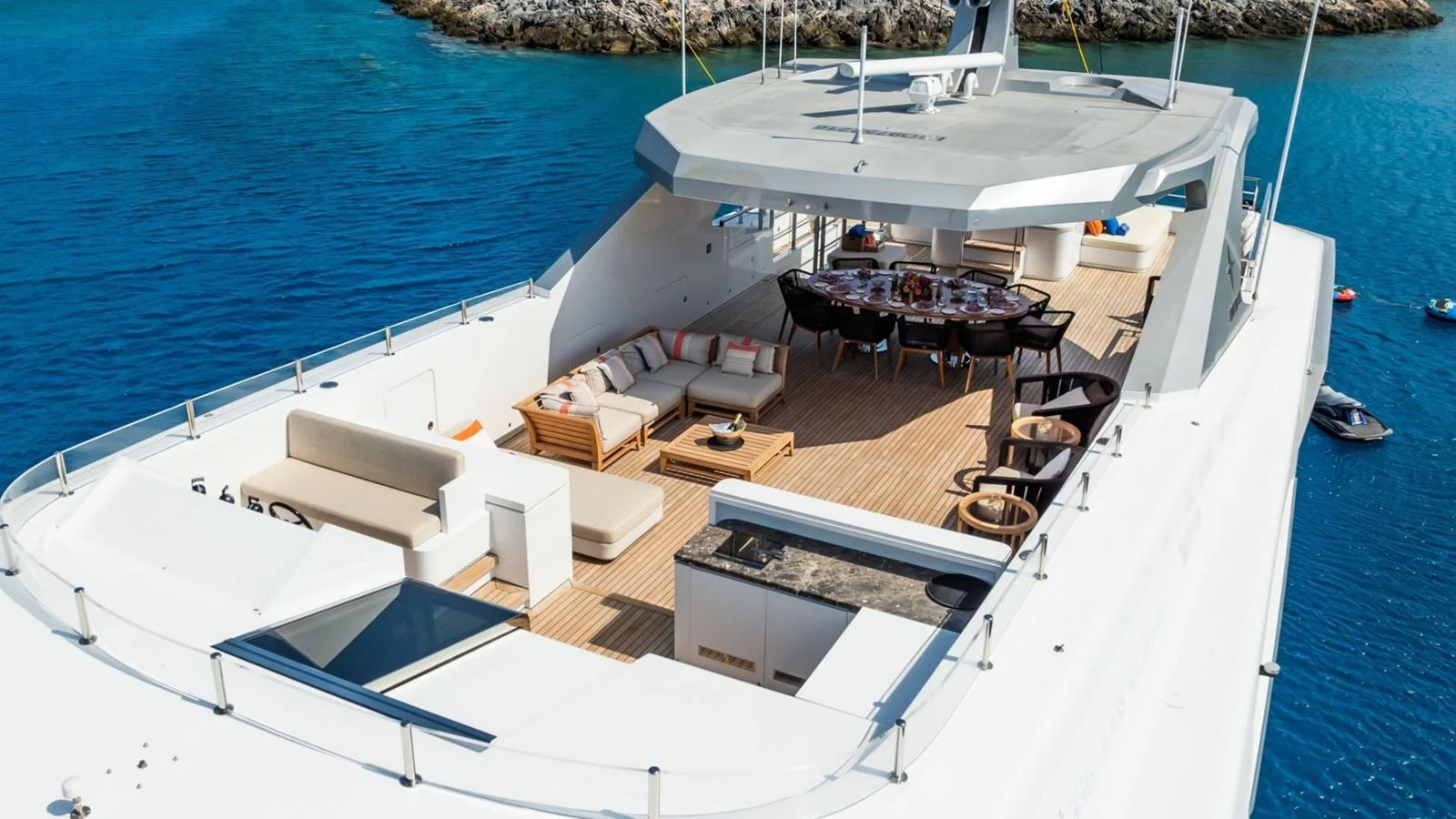 The flybridge offers a spacious and luxurious outdoor living area with ample seating and dining options. aboard BLUE MOON Yacht for Sale