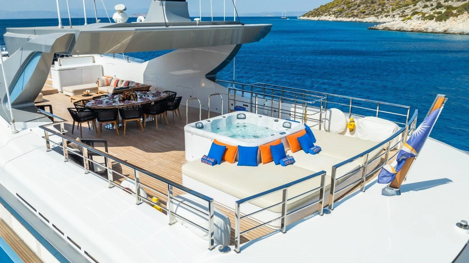 The sundeck features a luxurious hot tub and a stylish dining area with stunning ocean views. aboard BLUE MOON Yacht for Sale