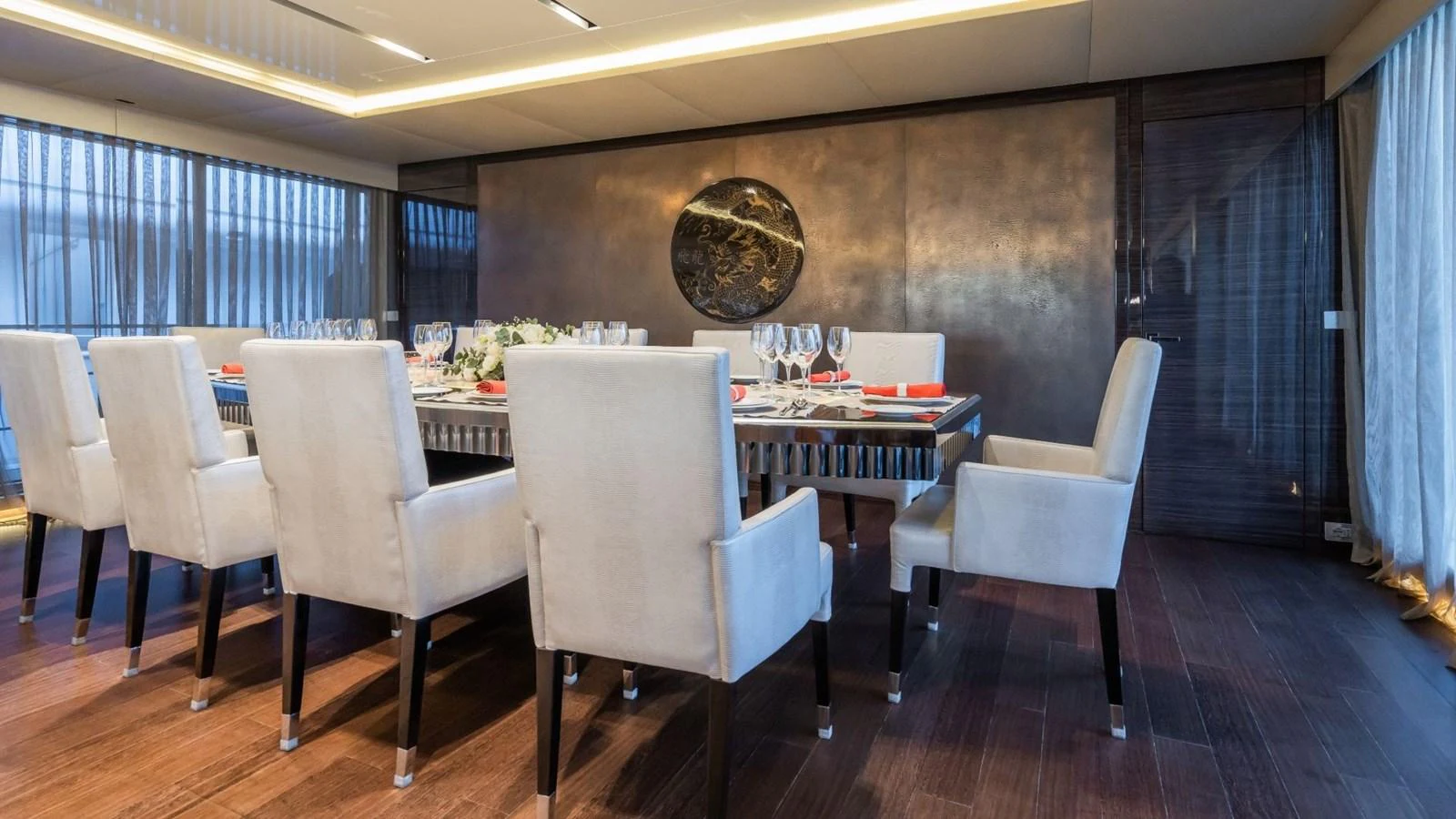 The yacht's dining area features a sophisticated table setting with plush chairs and elegant decor. aboard BLUE MOON Yacht for Sale