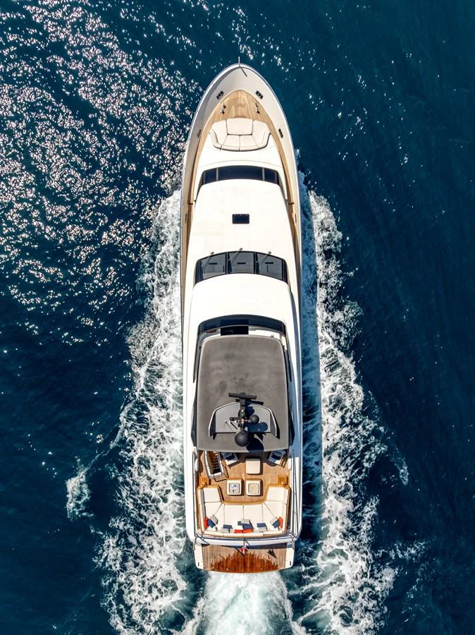 A stunning aerial view of a luxurious yacht cruising through the water. aboard CALM Yacht for Sale