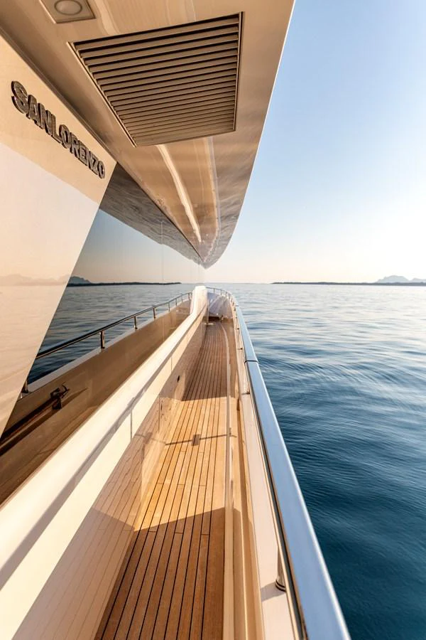 A sleek side deck of a yacht with a beautiful view of the calm sea. aboard CALM Yacht for Sale