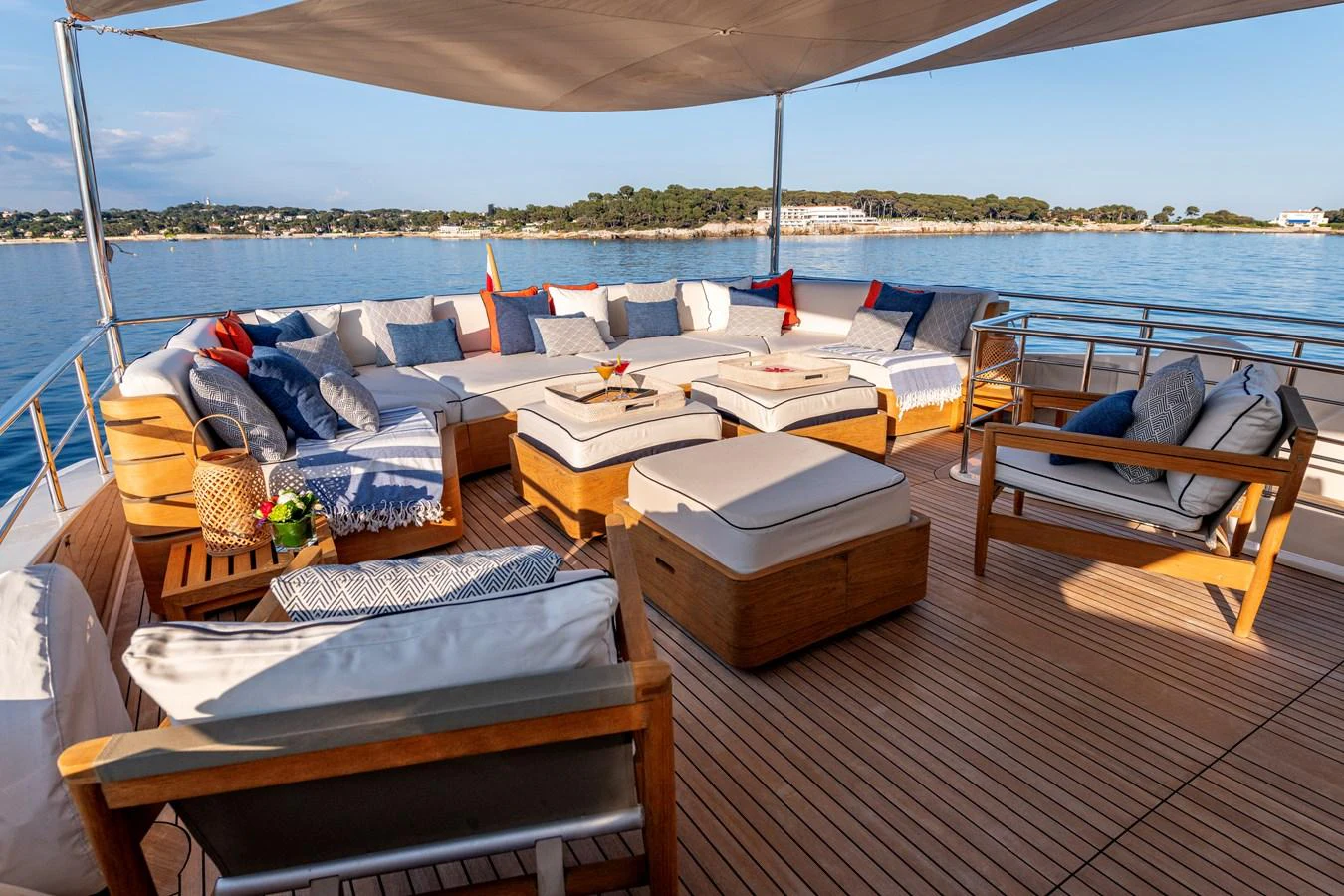 The aft deck features a spacious and inviting seating area with plush cushions and a stunning view of the water. aboard CALM Yacht for Sale