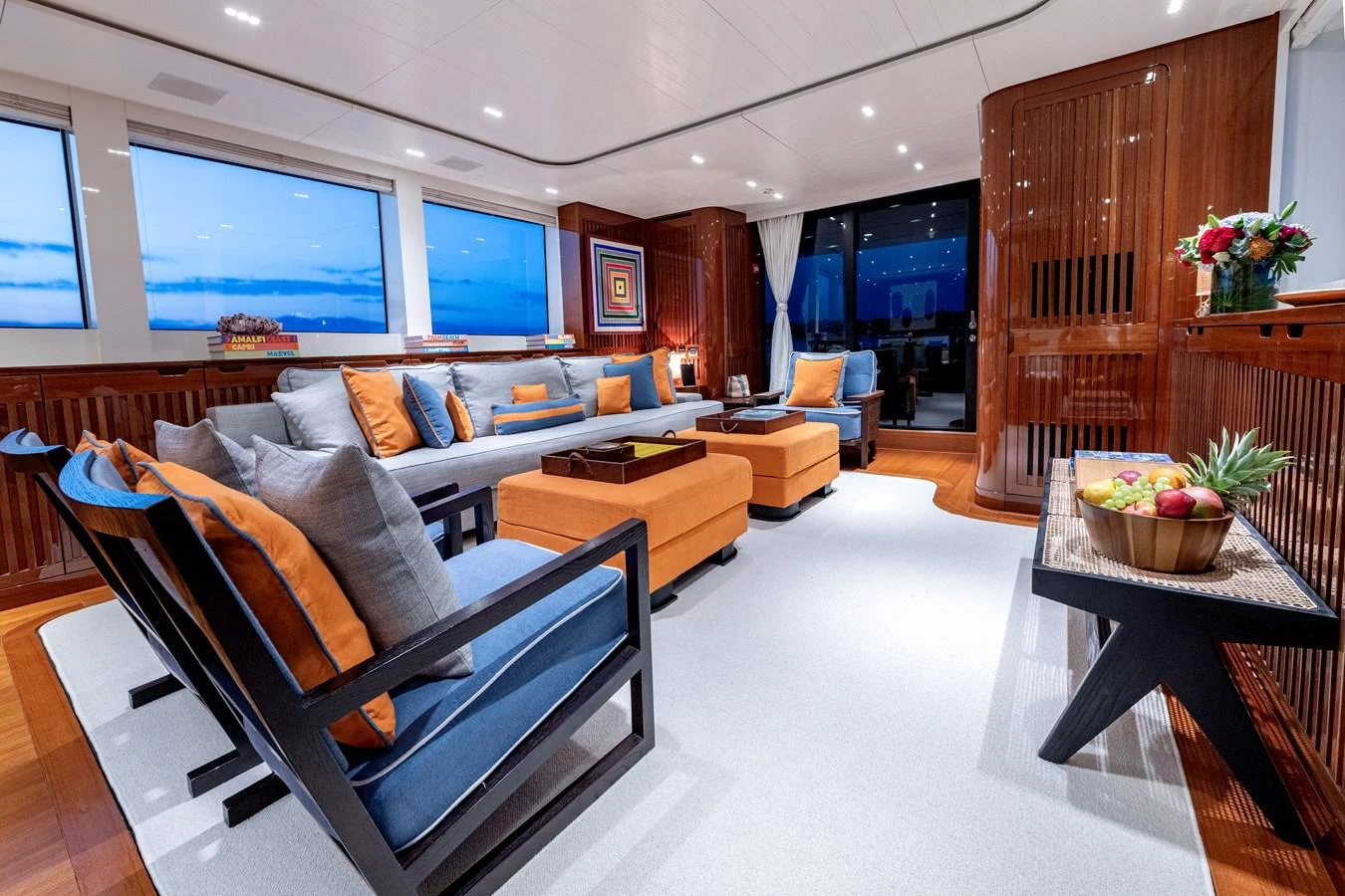 The salon features a spacious and elegantly designed seating area with large windows offering stunning views. aboard CALM Yacht for Sale